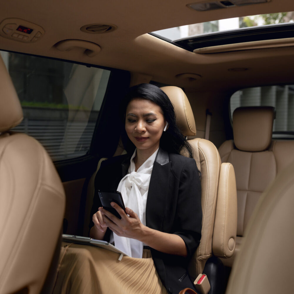 businesswoman-sitting-backseat-taxi